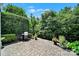 Outdoor patio with a grill, lush greenery, and neatly landscaped hedges at 2224 Hartwell Ln, Fort Mill, SC 29707