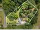Aerial view of a property, showing mature trees and landscaping, highlighted with a white border line at 2320 Doster Rd, Monroe, NC 28112