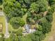 Expansive wooded property with a brick home featuring a metal roof, complemented by a convenient detached garage at 2320 Doster Rd, Monroe, NC 28112