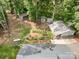 An aerial view of the home reveals large detached garage/workshop, mature trees, and metal roof at 2320 Doster Rd, Monroe, NC 28112