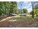 Large backyard with multiple storage buildings and mature trees with ample space at 2320 Doster Rd, Monroe, NC 28112