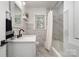 This newly renovated bathroom features marbled tile, a white vanity, and modern fixtures at 2320 Doster Rd, Monroe, NC 28112