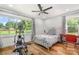 Sunlit bedroom with hardwood floors, exercise equipment, and a large window with backyard views at 2320 Doster Rd, Monroe, NC 28112