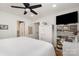 Bedroom with white walls, hardwood floors, ceiling fan, and ensuite bathroom at 2320 Doster Rd, Monroe, NC 28112