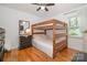 This bedroom features a wooden bunk bed, a dresser, and natural lighting from the window at 2320 Doster Rd, Monroe, NC 28112