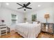 Bright bedroom featuring hardwood floors, white walls, ceiling fan, and great natural light at 2320 Doster Rd, Monroe, NC 28112