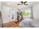 Bright bedroom features exercise equipment, a hardwood floor, and a large window with a view at 2320 Doster Rd, Monroe, NC 28112