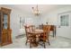 Bright dining area with wooden furniture, a chandelier, and access to the backyard at 2320 Doster Rd, Monroe, NC 28112
