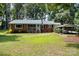 Charming ranch home with a brick exterior, a carport, a well-manicured lawn, and mature trees at 2320 Doster Rd, Monroe, NC 28112