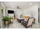 Cozy living room featuring neutral tones, patterned tile floors, modern ceiling fan, and comfortable seating at 2320 Doster Rd, Monroe, NC 28112