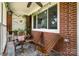 Cozy screened porch with comfortable wooden chairs, ceiling fan and decorative plants at 2320 Doster Rd, Monroe, NC 28112