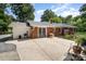 Brick home with a metal roof, an outdoor grill, and a large concrete patio at 2320 Doster Rd, Monroe, NC 28112