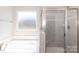 Bright bathroom with a soaking tub, glass-enclosed shower, and modern fixtures at 236 Mountain Island Rd # 40, Statesville, NC 28677