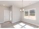 Dining room with a large window, modern light fixture, and adjacent door to the exterior at 236 Mountain Island Rd # 40, Statesville, NC 28677