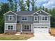 Charming two-story home with stone accents, a two-car garage, and a well-manicured lawn at 236 Mountain Island Rd # 40, Statesville, NC 28677