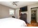 Bedroom featuring a window, dresser, and television creating a comfortable retreat at 2443 Knickerbocker Dr, Charlotte, NC 28212
