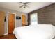 Bright bedroom featuring an accent wall, closet, television, ceiling fan, and a sunlit window at 2443 Knickerbocker Dr, Charlotte, NC 28212