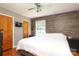 Bedroom with a ceiling fan and accent wall; a TV is mounted between two doors at 2443 Knickerbocker Dr, Charlotte, NC 28212