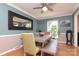 Traditional dining room featuring a gray table with bench seating, blue accent wall, and wood floors at 2443 Knickerbocker Dr, Charlotte, NC 28212