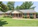 Charming brick home with a well-maintained lawn and inviting front porch at 2443 Knickerbocker Dr, Charlotte, NC 28212