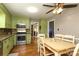 Eat-in kitchen featuring light green cabinets, hardwood floors, stainless appliances, and granite countertops at 2443 Knickerbocker Dr, Charlotte, NC 28212