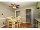 Eat-in kitchen featuring light green cabinets, hardwood floors, stainless appliances, and granite countertops at 2443 Knickerbocker Dr, Charlotte, NC 28212