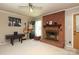 Inviting living room featuring a brick fireplace, neutral walls, guitars on the wall and a ceiling fan at 2443 Knickerbocker Dr, Charlotte, NC 28212