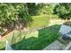 Aerial view of fenced backyard, featuring lush green lawn, mature trees, and private outdoor space at 2548 Chasewater Dr, Fort Mill, SC 29707