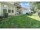Backyard features lush green lawn, outdoor seating area with mature trees and neutral exterior at 2548 Chasewater Dr, Fort Mill, SC 29707