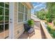 Cozy balcony with a comfortable chair, table, and view of the landscaped yard at 2548 Chasewater Dr, Fort Mill, SC 29707