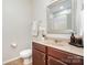 Bathroom featuring a wood vanity, decorative mirror, and neutral tile flooring at 2548 Chasewater Dr, Fort Mill, SC 29707
