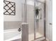 Bright bathroom featuring a shower with glass door and tile surround at 2548 Chasewater Dr, Fort Mill, SC 29707
