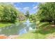 Picturesque pond with a central fountain, surrounded by lush greenery and mature trees at 2548 Chasewater Dr, Fort Mill, SC 29707