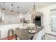 Bright dining area showcases a modern table setting, with an open view of the kitchen and living spaces at 2548 Chasewater Dr, Indian Land, SC 29707
