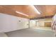 Unfinished basement featuring concrete walls, concrete floor, fluorescent lighting, and side room at 300 Caldwell St, Kannapolis, NC 28083