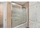 Bathroom with sliding shower doors and built-in cabinets for storage at 300 Caldwell St, Kannapolis, NC 28083