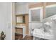 Bathroom with vanity, built-in cabinets, and mirror with decorative gold frame at 300 Caldwell St, Kannapolis, NC 28083