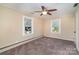 Bedroom featuring neutral walls, carpeted floor, ceiling fan, and two windows at 300 Caldwell St, Kannapolis, NC 28083