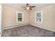 Bedroom featuring neutral walls, carpeting, ceiling fan, and two windows at 300 Caldwell St, Kannapolis, NC 28083