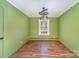 Empty room with green painted walls, hardwood floors, and abundant natural light from one window at 300 Caldwell St, Kannapolis, NC 28083