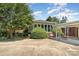 Charming single story brick home featuring long driveway, carport and large shrubbery at 300 Caldwell St, Kannapolis, NC 28083