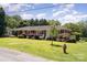 Charming one-story brick home with a lush green lawn and mature landscaping at 300 Caldwell St, Kannapolis, NC 28083