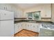 Bright kitchen with white cabinets, updated appliances, and hardwood floors at 300 Caldwell St, Kannapolis, NC 28083