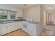 Functional kitchen with white cabinets, updated appliances, and hardwood floors at 300 Caldwell St, Kannapolis, NC 28083