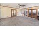 Spacious sun room featuring neutral carpet, brick accent wall, and glass paneled doors at 300 Caldwell St, Kannapolis, NC 28083