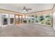 Bright sun room with large windows, wood trim, neutral carpet and ceiling fan at 300 Caldwell St, Kannapolis, NC 28083