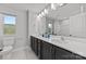 Bathroom featuring dual sinks, large mirrors, and updated fixtures at 3321 Treble Ct, Charlotte, NC 28262