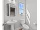Cozy bathroom with modern fixtures, a pedestal sink, white toilet and a view to the stairs at 3321 Treble Ct, Charlotte, NC 28262