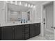 Bathroom featuring a double vanity, well-lit mirrors, and modern tile flooring at 3321 Treble Ct, Charlotte, NC 28262