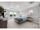 Bright bedroom with tray ceiling, large windows, and plush carpet at 3321 Treble Ct, Charlotte, NC 28262